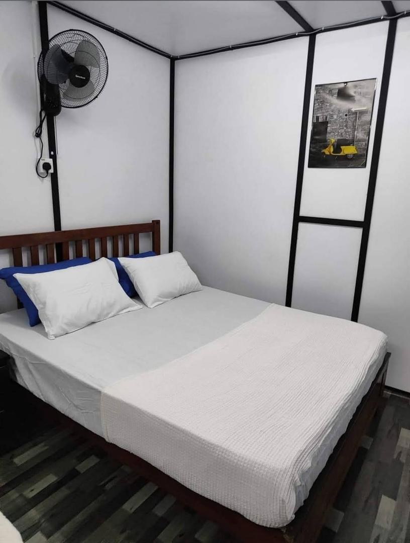 Queen bedroom interior with wall fan